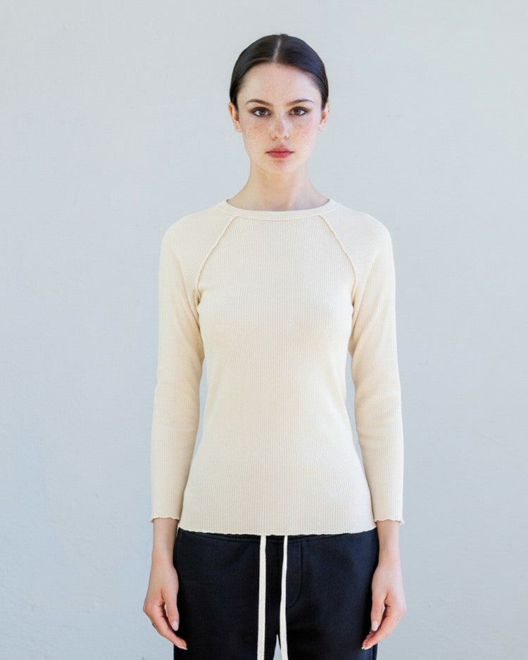Aria Rib Raglan Tee - Drift worn by a model, showcasing the soft fitted long sleeve design in a neutral tone.