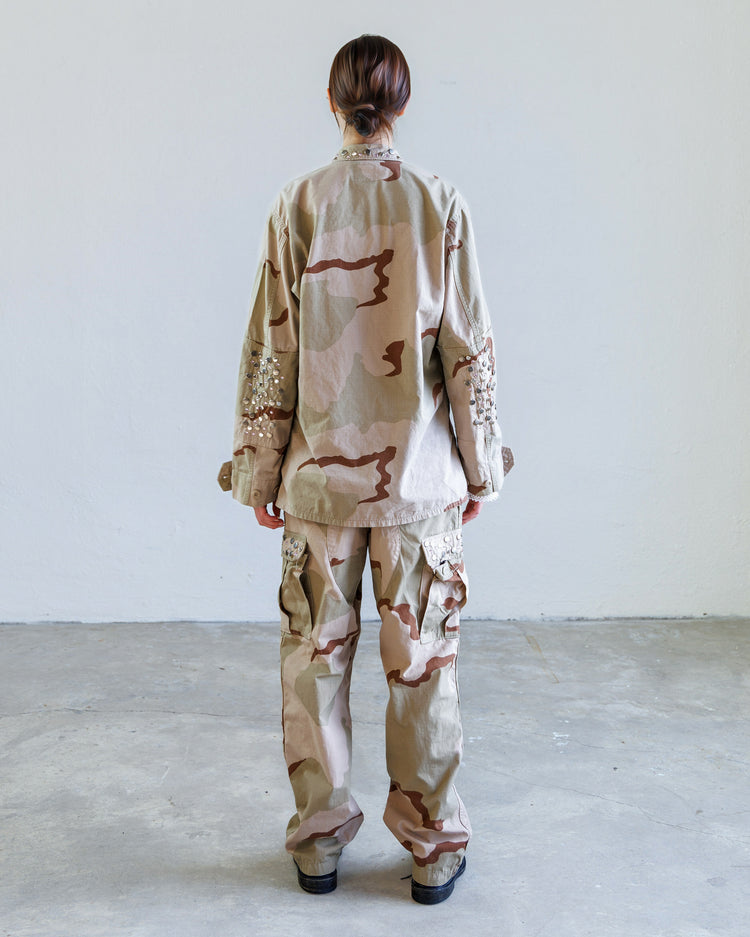 Scout Studded Twill Unisex Cargo Pant - Desert worn with matching camouflage jacket from the back in a minimalist space.
