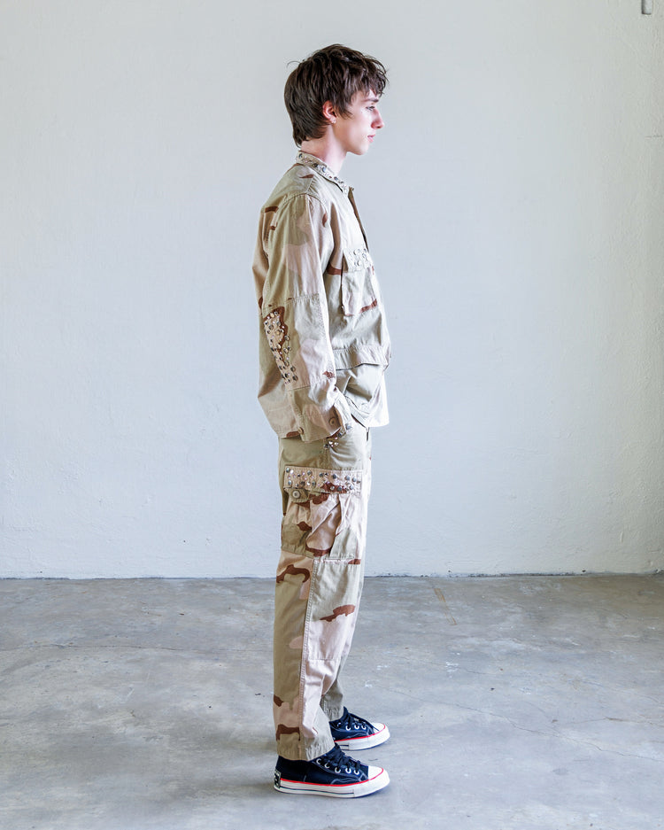 Model wearing Scout Studded Twill Unisex Cargo Pant - Desert, showcasing its straight leg fit and military-inspired design.