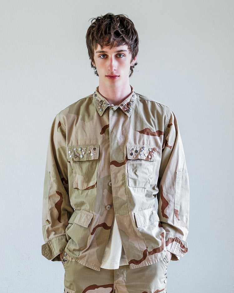 Austin Studded Twill BDU Unisex Jacket - Desert worn by a model, showcasing its unique design and features.