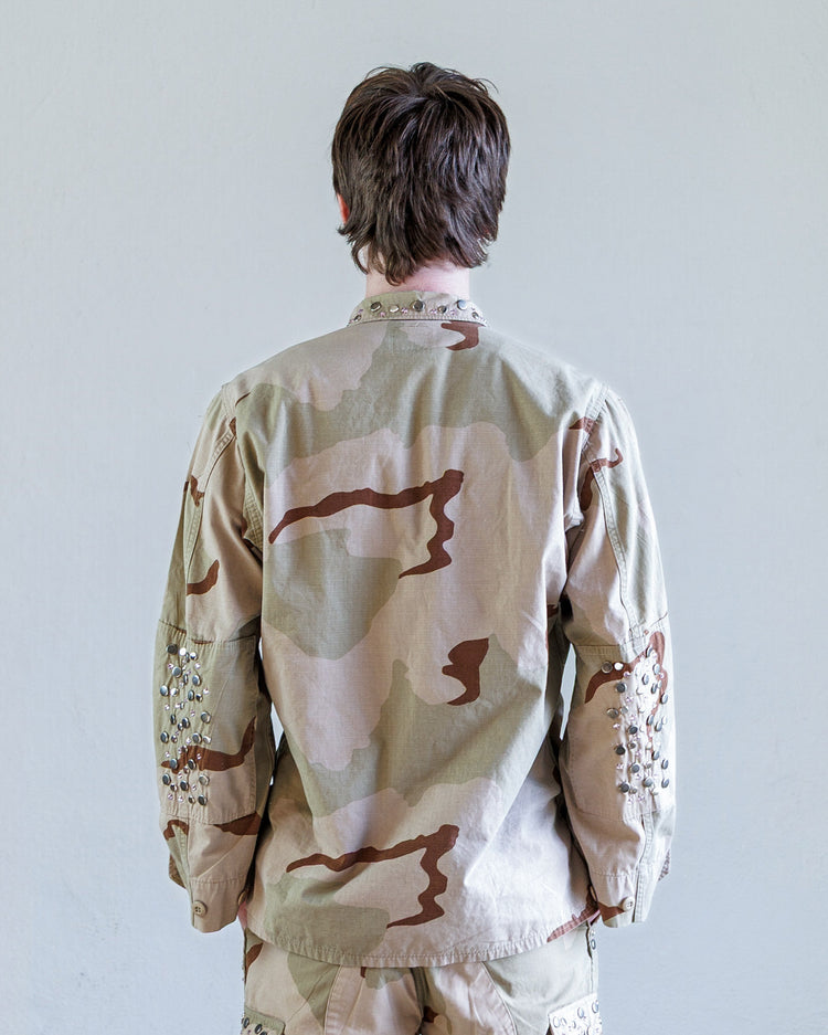 Austin Studded Twill BDU Unisex Jacket - Desert viewed from the back, featuring unique camouflage and studded detailing.