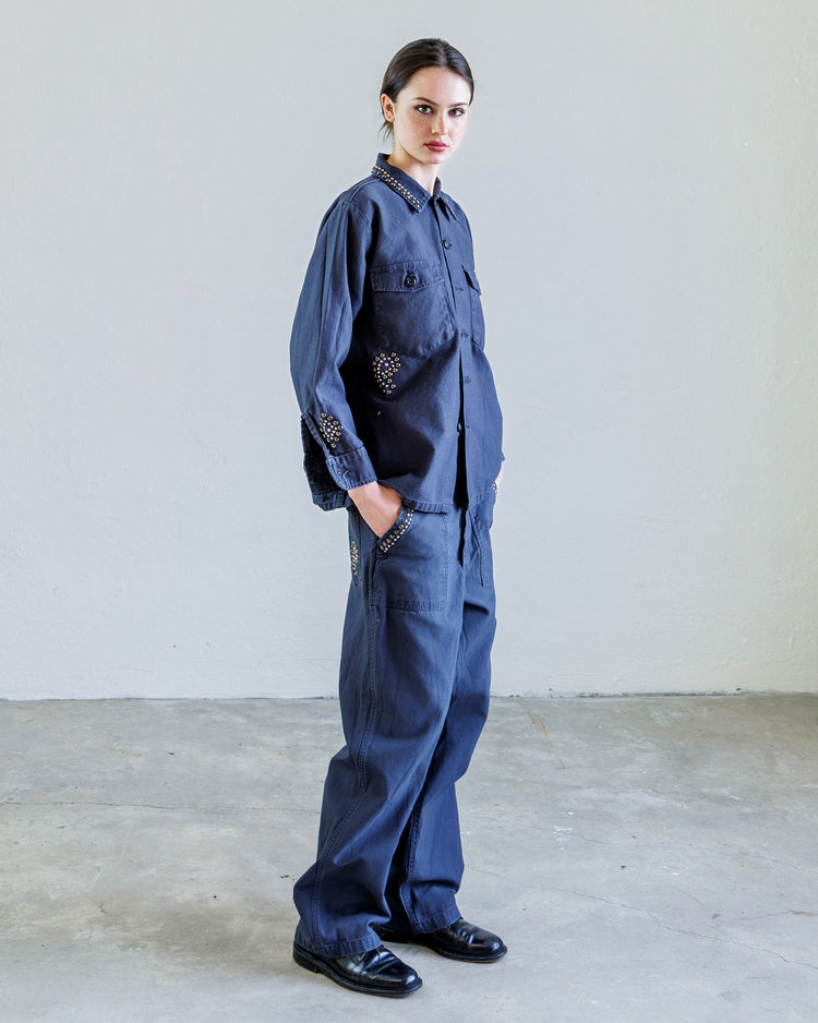 Wells Studded Sateen Women's Baker Pant - Navy showcased on a model in a minimalist setting.