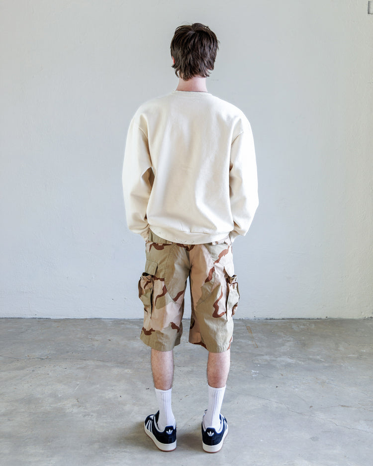 Person wearing Jesse Twill Unisex Cargo Short - Desert with a beige sweater, seen from the back.