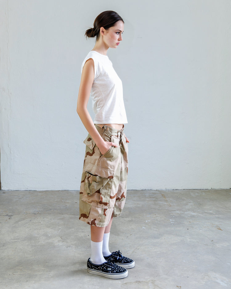 Model wearing Jesse Twill Unisex Cargo Short - Desert with white crop top and sneakers.