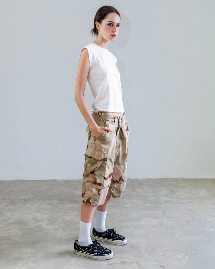 Jesse Twill Unisex Cargo Short - Desert worn by model in studio setting, showcasing military-inspired design and pocket details.