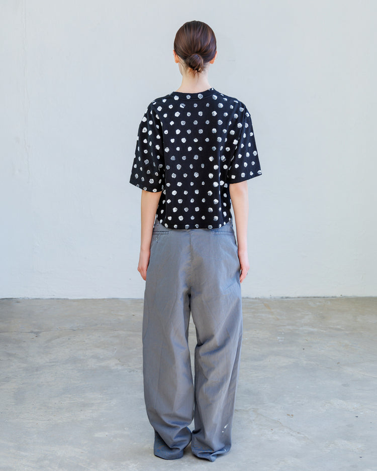 Turner Pleated Twill Unisex Trouser - Cement Workshop worn with a stylish polka dot shirt from the back view.