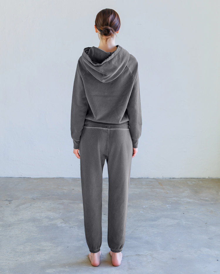 Sayde Loop Terry Sweatpant - Aged Black back view worn by a model showcasing the slim fit and premium fabric.