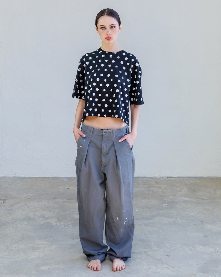 Turner Pleated Twill Unisex Trouser - Cement Workshop worn with a black polka dot cropped top, showcasing a relaxed silhouette.