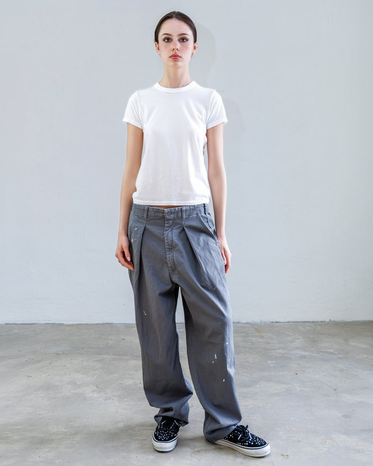 Model wearing Turner Pleated Twill Unisex Trouser - Cement Workshop with relaxed fit and front pleat design.