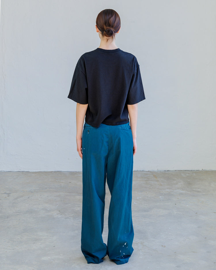 Turner Pleated Twill Unisex Trouser - Teal Workshop worn from the back by a model in a relaxed fit.