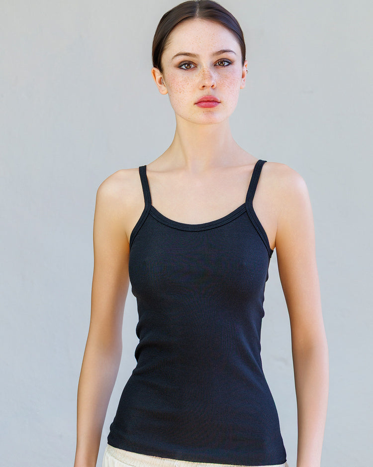 Kai Rib Cami Tank - Black worn by a model, featuring spaghetti straps and a fitted design.