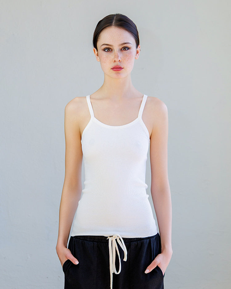 Model wearing the Kai Rib Cami Tank - Pearl with spaghetti straps and a slim fit.