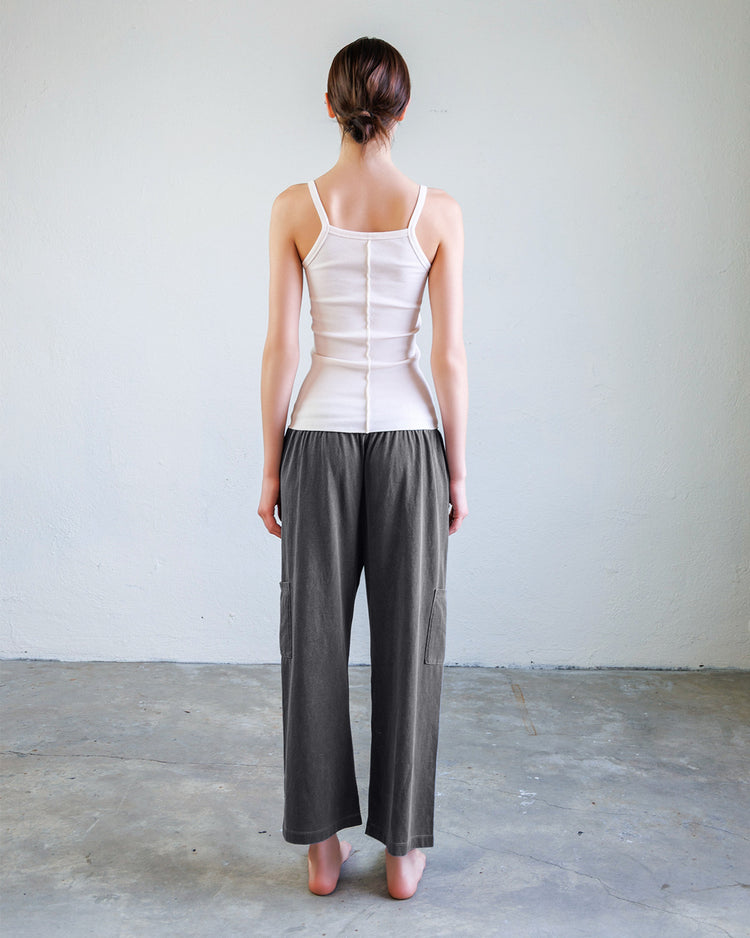 Nova Heavy Jersey Unisex Lounge Pant - Aged Black on model from behind, showcasing relaxed fit and cropped length.